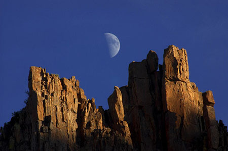 Half moon rising above the cliffs of Superstition Mountain